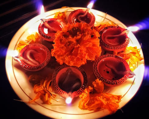 Diwali lamps and flowers on a plate
