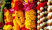 flower garlands hanging from a market stall