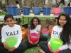 students holding buckets of Holi powder 2015